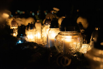 Glass lanterns on a grave - All Souls' Day decoration