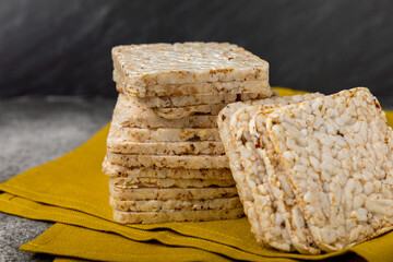 Round rice cakes on a  black table. Crispbread.Puffed rice bread. diet crispy round rice cakes.Place for text. Place for copy. Healthy food. dietary product.