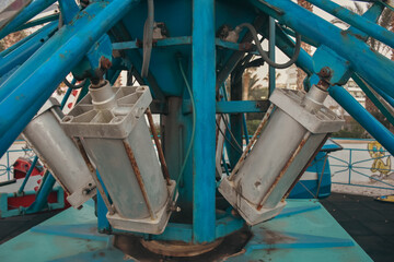 close-up of a carousel mechanical  parts at the amusement park.  Carousel motor and iron parts at the amusement park.