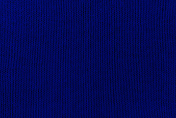 Knitted blue pattern closeup, detailed yarn background.