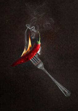 Red hot chili pepper with flame and smoke 
