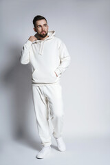 Handsome man wearing blank white hoodie and pants