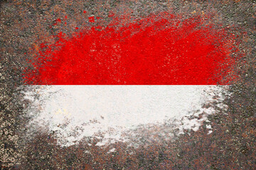 Flag of Monaco. Flag is painted on a rusty surface. Rusty background