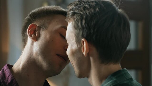 Authentic shot of young homosexual male couple passionate kissing each other. Men gay love and sexual attraction. LGBT relationship concept. 