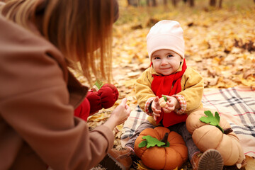  Mother and daughter having fun in autumn park. Happy family on walk. High quality photo