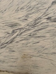 sand and water making abstract patterns 