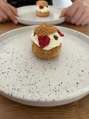 Choux pastry with whipped cream and raspberry 
