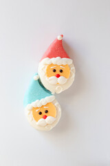 two sweet dessert in the form of a Santa Claus head, with a red and blue cap