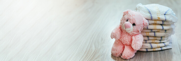 Diapers with a pink teddy bear. Hygiene of newborns.