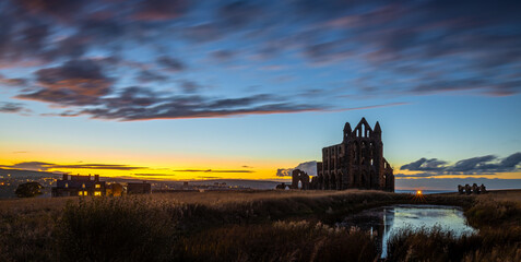 Sunset view of Whitby abbey overlooking the North Sea on the East Cliff above Whitby in North...