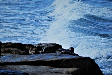 Close-up shot of rocks on a wavy coast