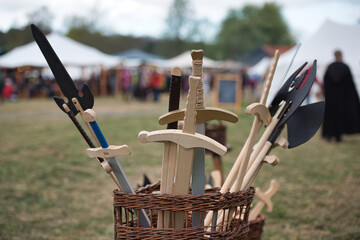 a stall selling wooden swords at a medieval market