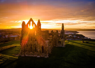 Sunset view of Whitby abbey overlooking the North Sea on the East Cliff above Whitby in North Yorkshire, England - obrazy, fototapety, plakaty
