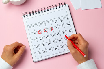 The concept of the menstrual cycle, period. The woman marks the days on the calendar. - 543535550