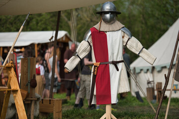 A suit of armor is presented at a medieval market