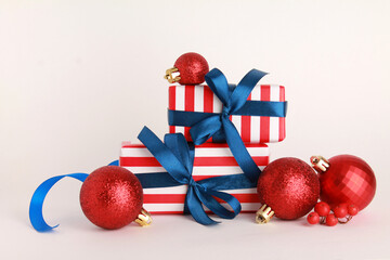 Wallpaper greeting card Merry Christmas holiday composition with blue striped gift box red present toy ball decoration on white background. Xmas New Year winter design idea concept. 