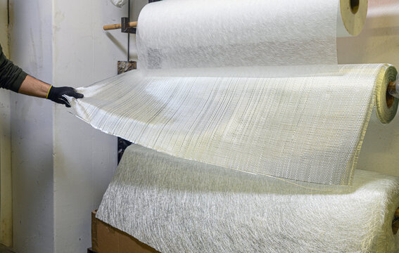 Installation of fiberglass sheets in various sizes ready for the creation of industrial composite material.