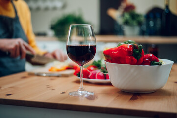 Red wine in a glass standing on a kitchen counter