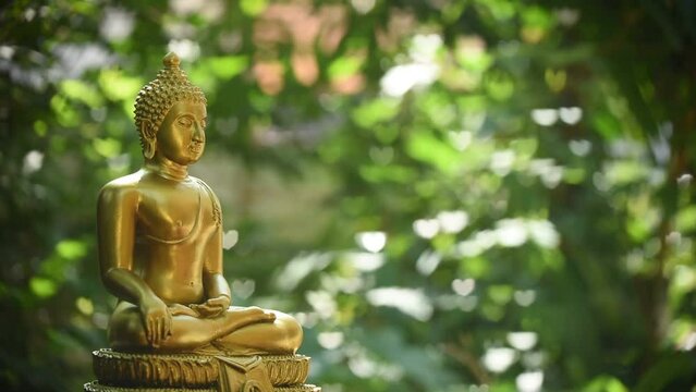 Buddha statue on colorful hearts boken nature background.