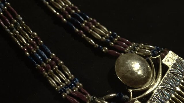 Golden ancient egyptian jewelry is one of the exhibits of the tomb of Tutankhamen, a symbol of Ancient Egypt. Shot in motion. Closeup