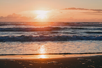 Beautiful sunset with a little of clouds on the Pacific ocean beach