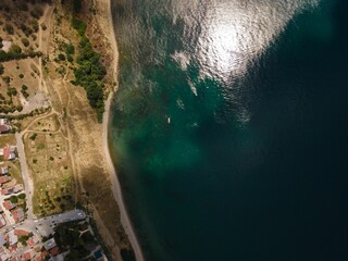 Areal shot of the green sea approaching the coastline