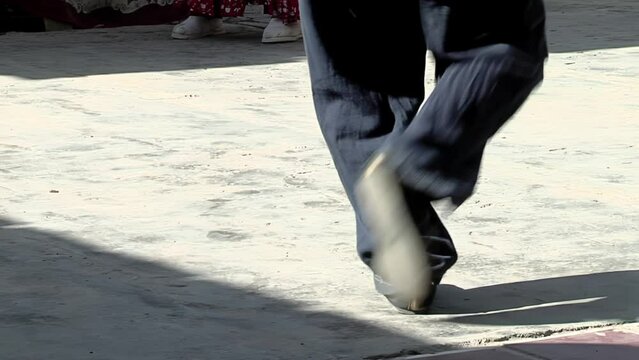Young Dancer Stomping His Feet (Zapateo) while Dancing "Chacarera", an Argentine Folklore Dance originated in Santiago del Estero province, Argentina. Low Angle View. Close Up.  