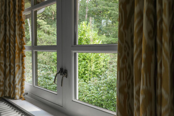 Old fashioned window with beautiful curtains in room. Interior design