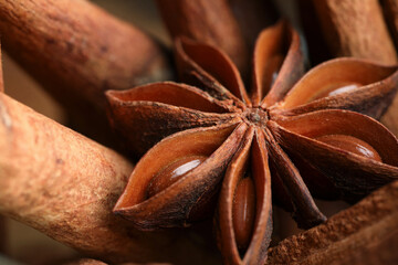 Aromatic cinnamon sticks and anise star as background, closeup