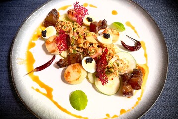 Scallops with Caviar, Quail egg and sweet pork condiments served with Thai style spicy herbs salad....