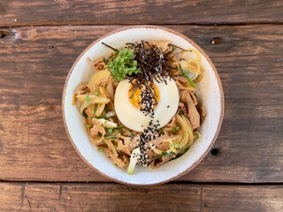 Teriyaki pork donburi rice bowl with omelette and seaweed. Famous Japanese food. Selective focus with copy space