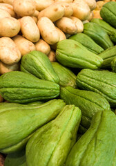 Fresh chayote and potato at the supermarket. Vegetables and fruits exposed for the consumer to choose