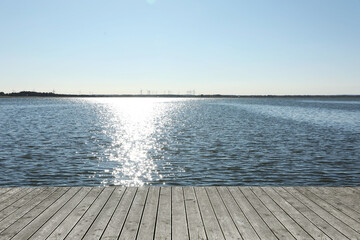 Beautiful view of wooden terrace near river on sunny day