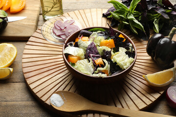 Delicious salad with Chinese cabbage, tomato and basil served on wooden table