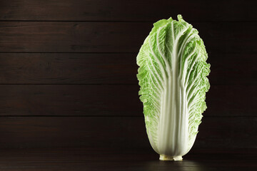 Fresh ripe Chinese cabbage on table against wooden background. Space for text