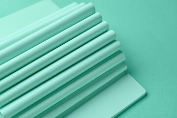 Notebook with folded pages on mint background