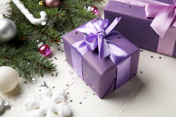 Christmas gifts on light wooden table, closeup