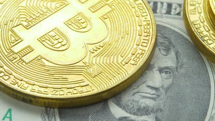 Virtual coin Bitcoin on american Five dollars bills. Money or cash, cryptocurrency, trade concept. Record high boosted by increased demand. Abraham Lincoln, 16th president of USA on banknote