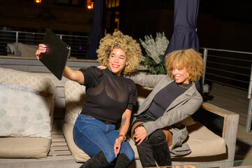 African-American Sisters with Blonde Afros Out at Night