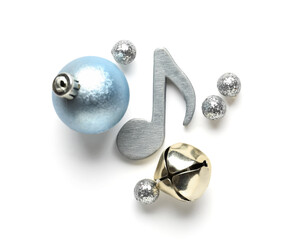 Note sign with Christmas balls and bell on white background