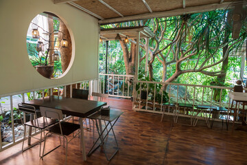 Restaurant interior with beautiful spring trees and garden