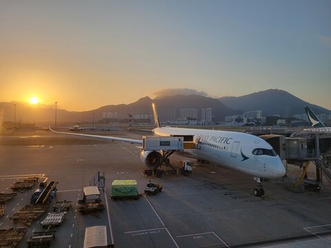 Cathay Pacific Airbus A350 parked at gate at Hong Kong International Airport at sunrise - Hong Kong