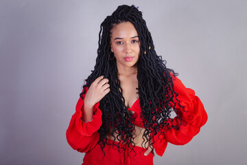 Beautiful black Brazilian woman, dressed in red. messing with the hair.