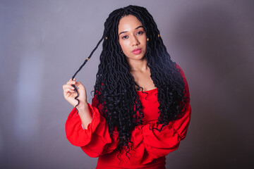 Beautiful black Brazilian woman, dressed in red. messing with the hair.