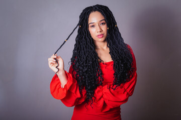 Beautiful black Brazilian woman, dressed in red. messing with the hair.