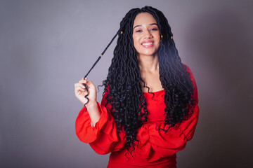 Beautiful black Brazilian woman, dressed in red. messing with the hair.