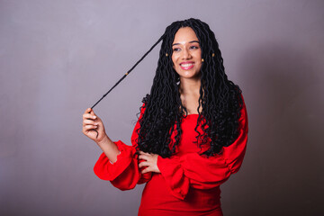 Beautiful black Brazilian woman, dressed in red. messing with the hair.