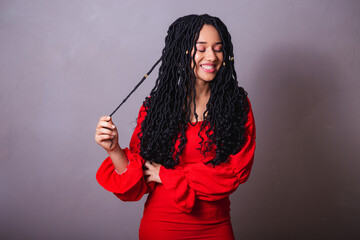Beautiful black Brazilian woman, dressed in red. messing with the hair.