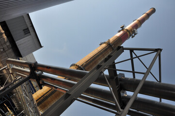 Chimney in old and rusted heating plant, stack in an old electrical power and heating station, industrial building, old factory