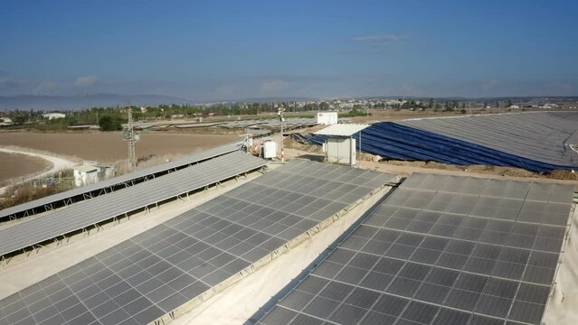 Aerial shot of an agricultural water reservoir surrounded by fields. Irrigation concept
